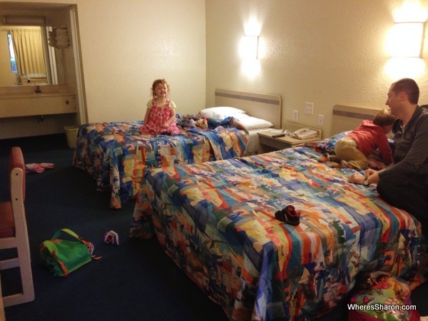 family sitting in beds in motel 6 tallahassee